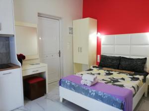 a bedroom with a bed with a stuffed animal on it at Spiros Rooms in Kastrosikia