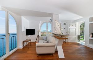 a living room with a couch and a table with a boat on it at Bellevue Syrene in Sorrento
