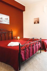 a bedroom with a bed with a red bedspread at B&B Raggio di Sole in Porto Empedocle