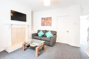 a living room with a couch and a table at Fantastic Location - TV in Every Bedroom! in Swansea