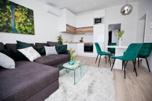 a living room with a couch and a table and chairs at Luxury Apartments Mia in Podstrana