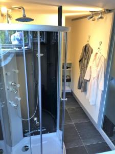 a walk in shower in a bathroom with a glass shower stall at B&B Landgoed Bergerven in Horn