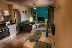 a kitchen and living room with a table and chairs at New central town Bungalow WiFi Netflix in Caleta De Fuste