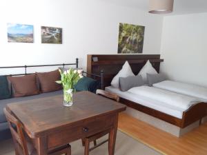 a living room with a couch and a table at FREE Apartment - Burgblick in Bad Urach