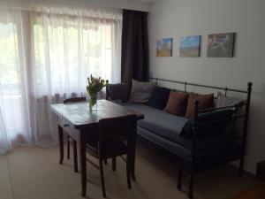 a living room with a couch and a table at FREE Apartment - Burgblick in Bad Urach