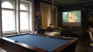 a living room with a pool table and a tv at Vitae Hostel in Budapest