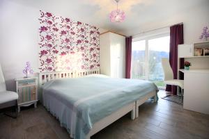 a bedroom with a bed and a large window at Hainhof Gaestewohnungen in Bad König