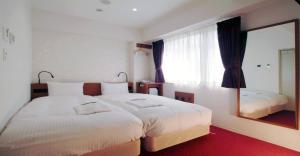 大阪的住宿－Benikea Calton Hotel Osaka Doutonbori，一间卧室设有两张床和大镜子