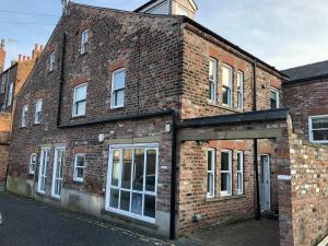 an old brick building on the side of a street at Easy Walk City Centre Flat with Free Parking in York