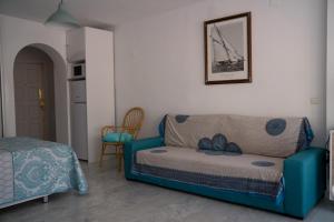 a living room with a couch and a table at Apartamento Punta de Torrox in Torrox +13 photos