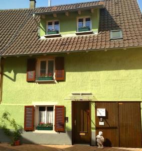 a teddy bear sitting outside of a green house at Grüne Franziska in Ettenheim