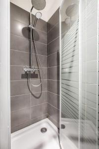 a shower with a glass door in a bathroom at 3 Chambres au cœur du vieux Lille in Lille