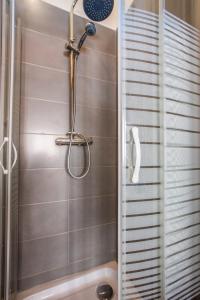 a shower with a shower head in a bathroom at 3 Chambres au cœur du vieux Lille in Lille +12 photos