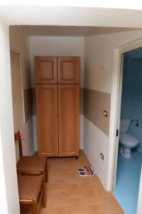 a bathroom with a cabinet and a toilet in it at Guest House Taunus in Berat +68 photos