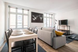 a living room with a table and a couch at 3 Chambres au cœur du vieux Lille in Lille