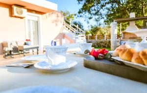 a table with plates of food and cups on it at Villa Archontiki I - Private Pool in Vryses
