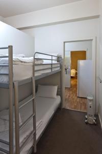 a room with two bunk beds and a mirror at City Centre Budget Hotel in Melbourne