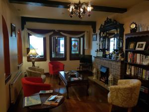 a living room with a table and chairs and a fireplace at Lynch's in Kilkee