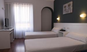 Postel nebo postele na pokoji v ubytování Hotel Gran Regente
