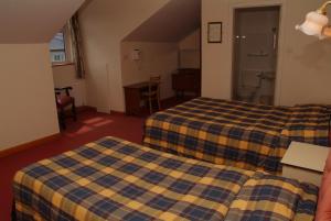 Postel nebo postele na pokoji v ubytování Sancta Maria Hotel