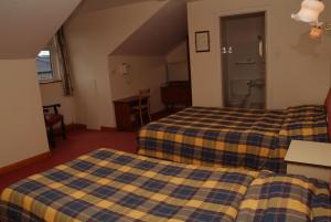 Postel nebo postele na pokoji v ubytování Sancta Maria Hotel