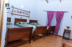 Un ou plusieurs lits dans un hébergement de l'établissement Hostal y Cabañas Aorangi