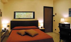 a bedroom with a bed with orange sheets and a window at Locanda A Cà Du Gigante in Monterosso al Mare