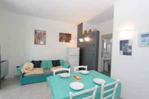 a living room with a blue table and a couch at Residence Vives in Comacchio