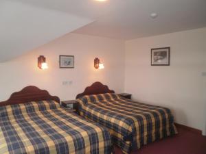 Postel nebo postele na pokoji v ubytování Sancta Maria Hotel