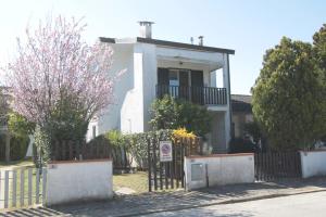 a house with a fence in front of it at Residence Vives in Comacchio