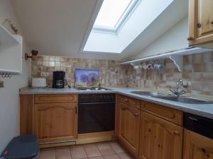 a kitchen with a sink and a stove at Ferienwohnung-Himmelblau-auf-dem-Ferien-Bauernhof-Nielson-in-Bisdorf-in-Inselmitte in Bisdorf +17 photos