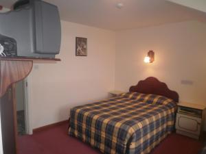 Ένα ή περισσότερα κρεβάτια σε δωμάτιο στο Sancta Maria Hotel