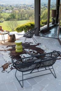 two black chairs sitting on a patio with a view at CHAMBRE AVEC VUE in Domessin