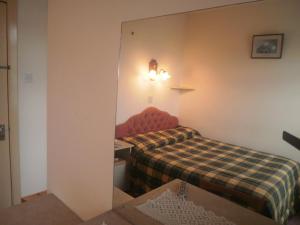 Postel nebo postele na pokoji v ubytování Sancta Maria Hotel