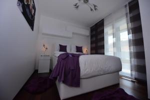 Postel nebo postele na pokoji v ubytování Apartmani FAMILY