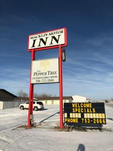 a sign for a store in a parking lot at Macklin Motor Inn in Macklin