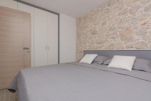 Posteľ alebo postele v izbe v ubytovaní Apartmani Mustaća dvori