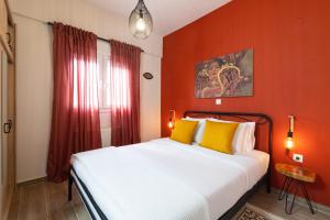 テッサロニキにあるF & B Collection - Apartment for 6のベッドルーム1室(オレンジ色の壁のベッド1台、黄色の枕付)