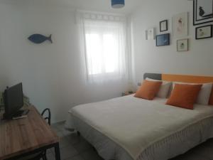 a bedroom with a bed, desk, and lamp at Carilla B&B in Carloforte
