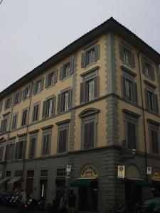 a large building with people standing outside of it at 27 Aprile in Florence