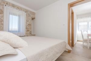 Posteľ alebo postele v izbe v ubytovaní Apartmani Mustaća dvori