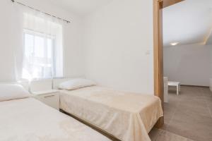 Posteľ alebo postele v izbe v ubytovaní Apartmani Mustaća dvori