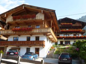 a building with cars parked in front of it at Haus Gmahblick Appartments in Alpbach