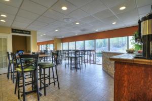 a bar with stools in a restaurant with windows at Edgewater Hotel and Conference Center in Gatlinburg