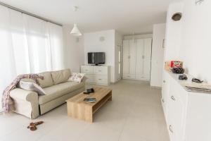 a living room with a couch and a coffee table at House Sunny Rock Baška in Jurandvor