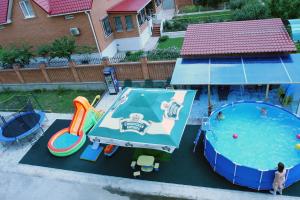 an overhead view of an outdoor swimming pool with a slide at Otel Hotel in Volgodonsk