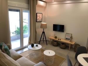 a living room with a couch and a tv at Votsalo in Kavala