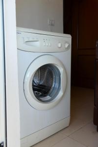 a white washer and dryer in a room at Guest House Taunus in Berat