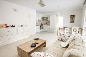 uma sala de estar branca com um sofá e uma mesa em House Sunny Rock Baška em Jurandvor