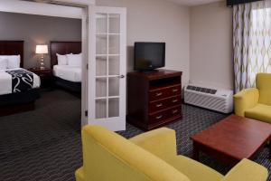 a hotel room with a bed and a television at La Quinta by Wyndham Indianapolis South in Indianapolis